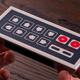 Imagen para el artículo titulado 8BitDo convirtió el gamepad clásico de la NES en un cargador inalámbrico